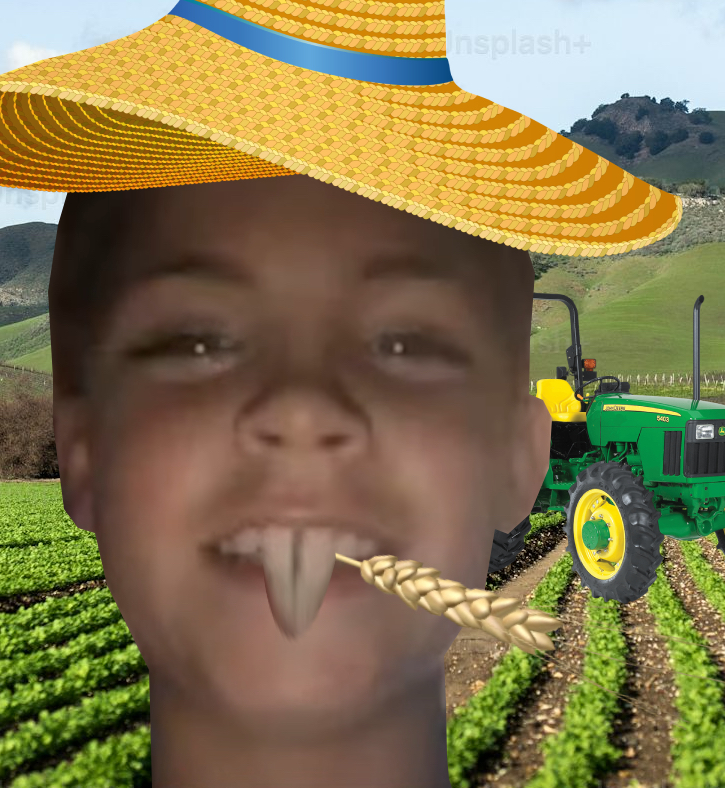 Caleb at the farm with his hat and wheat, with a green tractor in the background